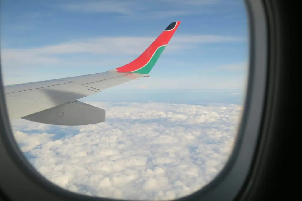 airplane wing over clouds from window view